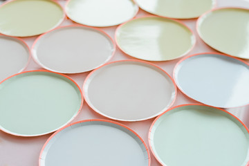 a variety of paper disposable plates of different colors