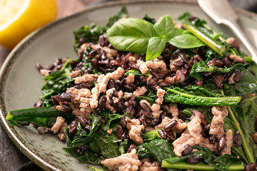 Brown Rice, Beef and Kale, with parsley, lemon, and olive oil, on a dark background. Blood Type Diet, blood type 0 and B.