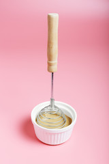  The process of making dalgona coffee on a pink background