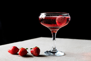 glass of red wine with strawberries