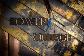 Photo of real authentic typeset letters Power Outage text on vintage textured grunge copper and...
