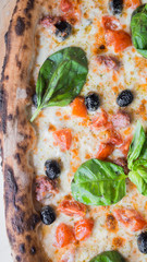 macro part of pizza margherita with olives classic