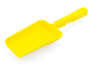 Yellow shoulder blade on a white background. Plastic shovel for playing in the sandbox. Blank for advertising children's toys, mock up