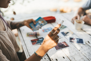 Woman is reading Tarot cards with a customer outdoors