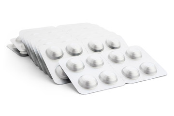 Lots of packages of pills and pills on a white background, close-up. Concept of medicine and healthcare. The idea of preventing and treating various diseases with medication. Coronavirus pandemic