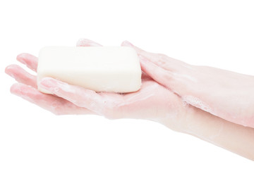 Soap hands holding a bar of soap, close-up, isolate on a white background. Mockup, a place for your label. The concept of cleanliness and hygiene. Sanitary norms and sanitary treatment of hands