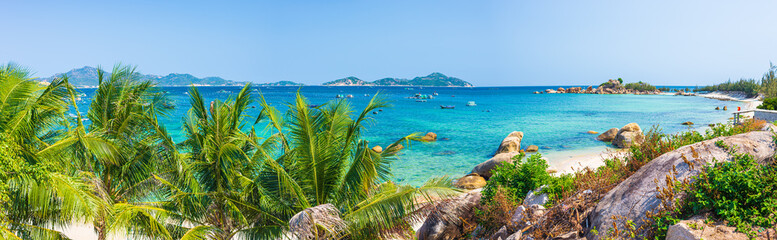 Secluded tropical coast line turquoise transparent water palm trees, undeveloped bay Quy Nhon Nha Trang, Vietnam central coast travel destination, no people clear blue sky, expansive view - obrazy, fototapety, plakaty