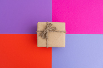 Spring gift in eco-friendly packaging on a light multicolored background.