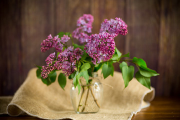 bouquet of beautiful blooming lilacs in a glass vase