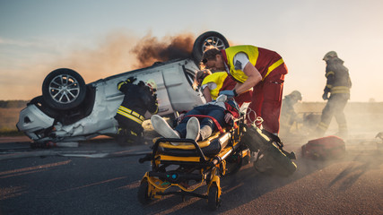 On the Car Crash Traffic Accident Scene: Paramedics Save Life of a Female Victim Lying on...