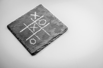 game TIC TAC toe on a black stone. the view from the top