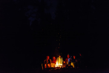 group of tourists are resting by the fire