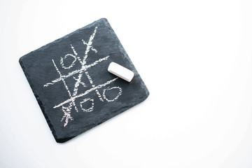game TIC TAC toe on a black stone. the view from the top - Powered by Adobe