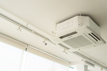picture of cassette type air conditioner or cooling system on the ceiling in the house. business...