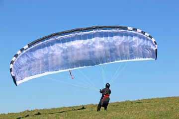 Paraglider launching at Milk Hill, England