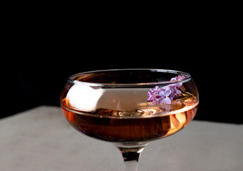 glass of cognac on black