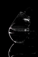 Fototapeta na wymiar Empty glass silhouette isolated on dark background