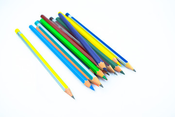 Fototapeta premium Stack of different colored wood pencil crayons placed on a white background