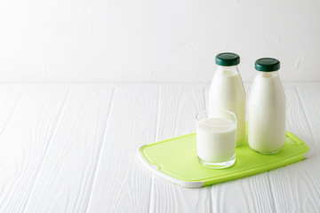 Homemade organic probiotic kefir drink or yogurt with probiotics on a white wooden background with copy space