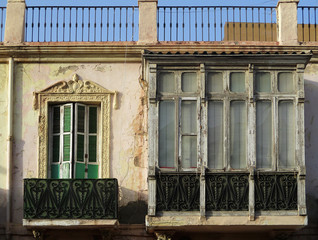Fototapeta na wymiar Traditional dilapidated facade with balconies in the city of Melilla. Spain.