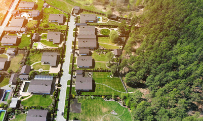 Aerial. Townhouse cottages near the forest. View above.