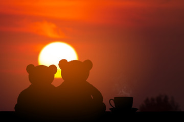 silhouette two bear and hot coffee at sunrise