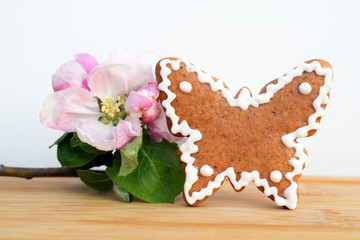 Romantic concept with gingerbread butterfly and spring blooming twig