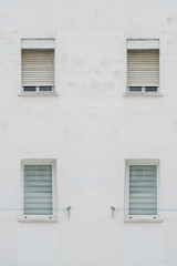white facade with four symmetrical windows