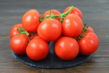 Fresh tomatoes on wooden background