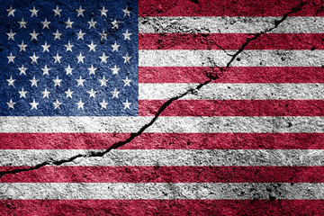 USA flag on cracked concrete wall. The concept of crisis, default, economic collapse, pandemic,...