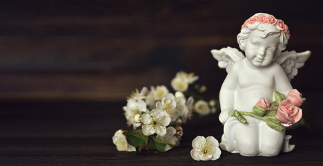 Guardian angel and spring flowers. Background or banner with copy space