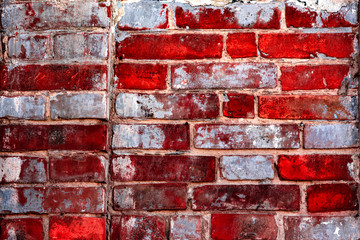 Texture of a brick wall with cracks and scratches which can be used as a background