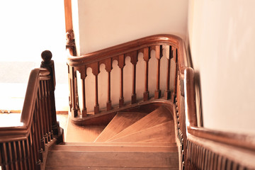 a wooden curved staircase open to the door