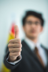 Businessman showing thumbs up, concept of successful business