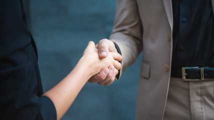 Two confident business man shaking hands during a meeting in the office, partner with business success concept.