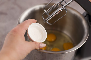 Eggs are beaten with a mixer and sprinkled with salt.