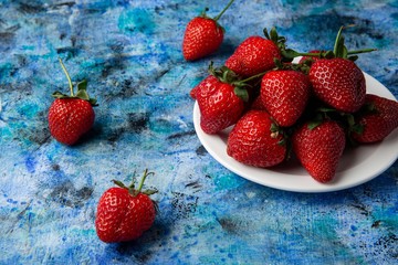 red strawberries on a blue background