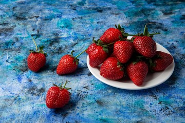 red strawberries on a blue background
