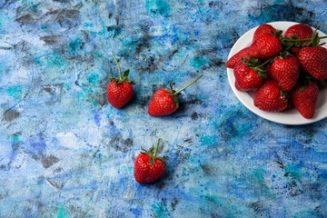 red strawberries on a blue background