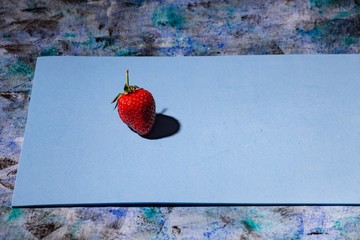 red strawberry on a blue background