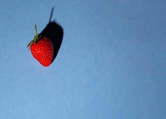 red strawberry on a blue background