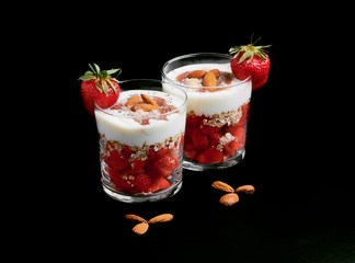 Fresh strawberries with soy yoghurt, oat flakes, almonds, red fruit jam, coconut flour and chia seeds.