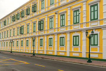 Fototapeta na wymiar Old classical yellow building facade in Bangkok Thailand.