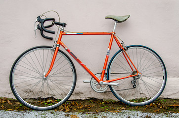 Naklejka na ściany i meble Bicycle repair. Wheel and shiny axle of chrome steel of an old road bike closeup. Retro bike. Red iron fork. Quick Release.
