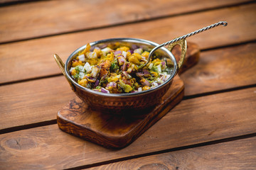 samosa chat masala spoon dish wooden board traditional indian cuisine