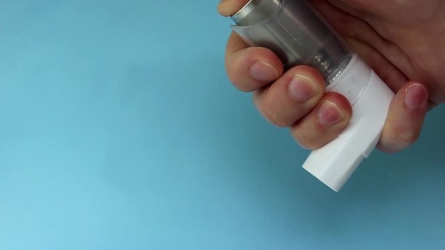 World Asthma Day May 5.anti-asthma inhaler on a blue background