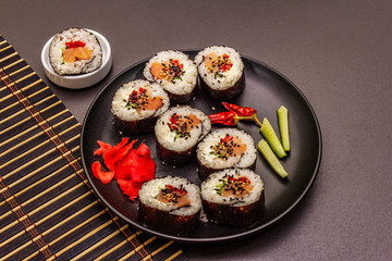 Korean roll Gimbap(kimbob). Steamed white rice (bap) and various other ingredients. Trendy black background