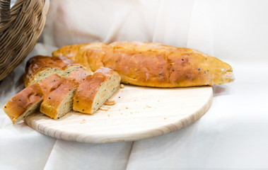 Sliced Sesame bread on wooden board, breads on breakfast table