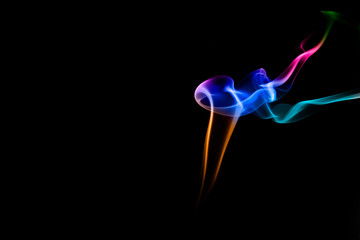 Abstract colored smoke on black background