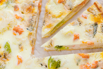 smoked salmon, Brussels sprouts and gorgonzola quiche tart, top view. Piece of homemade pie